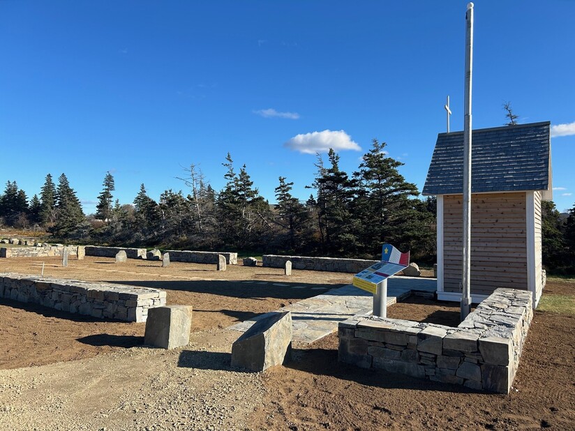 a picture of the work that has been done on the project site, includes an 18" high stone wall around the cemetery, new stone walkway, a regraded and crowned surface, and a refreshed chapel.